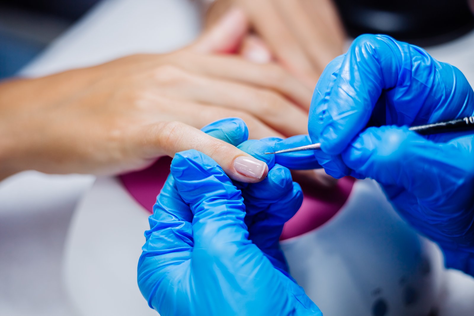 beautiful-female-hands-finger-nail-treatment-making-process-professional-nail-file-drill-action-beauty-hand-care-concept